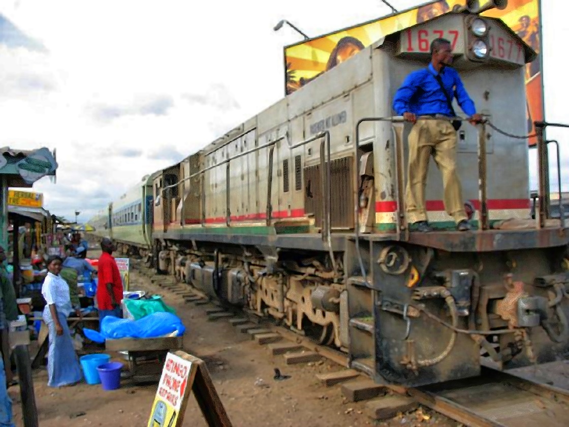Train in Accra with a watchman walking in front, around 2001