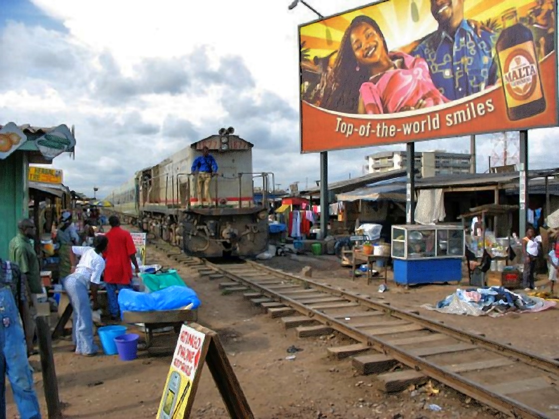 Train passing through a dense area near Accra station, around 2001