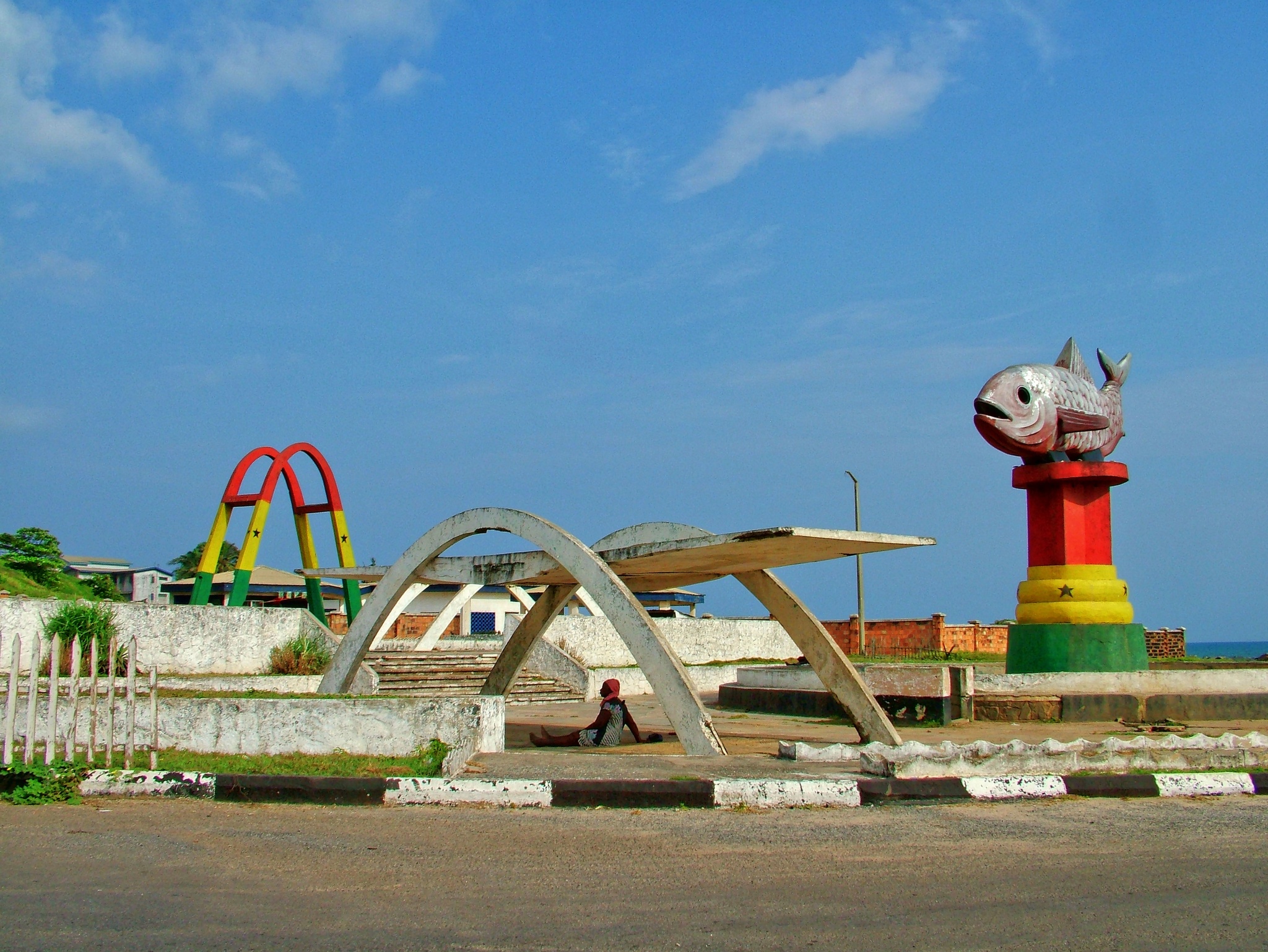 Independence Square in Sekondi-Takoradi with its arch and fish memorial painted in the red, gold and green of the Ghana flag